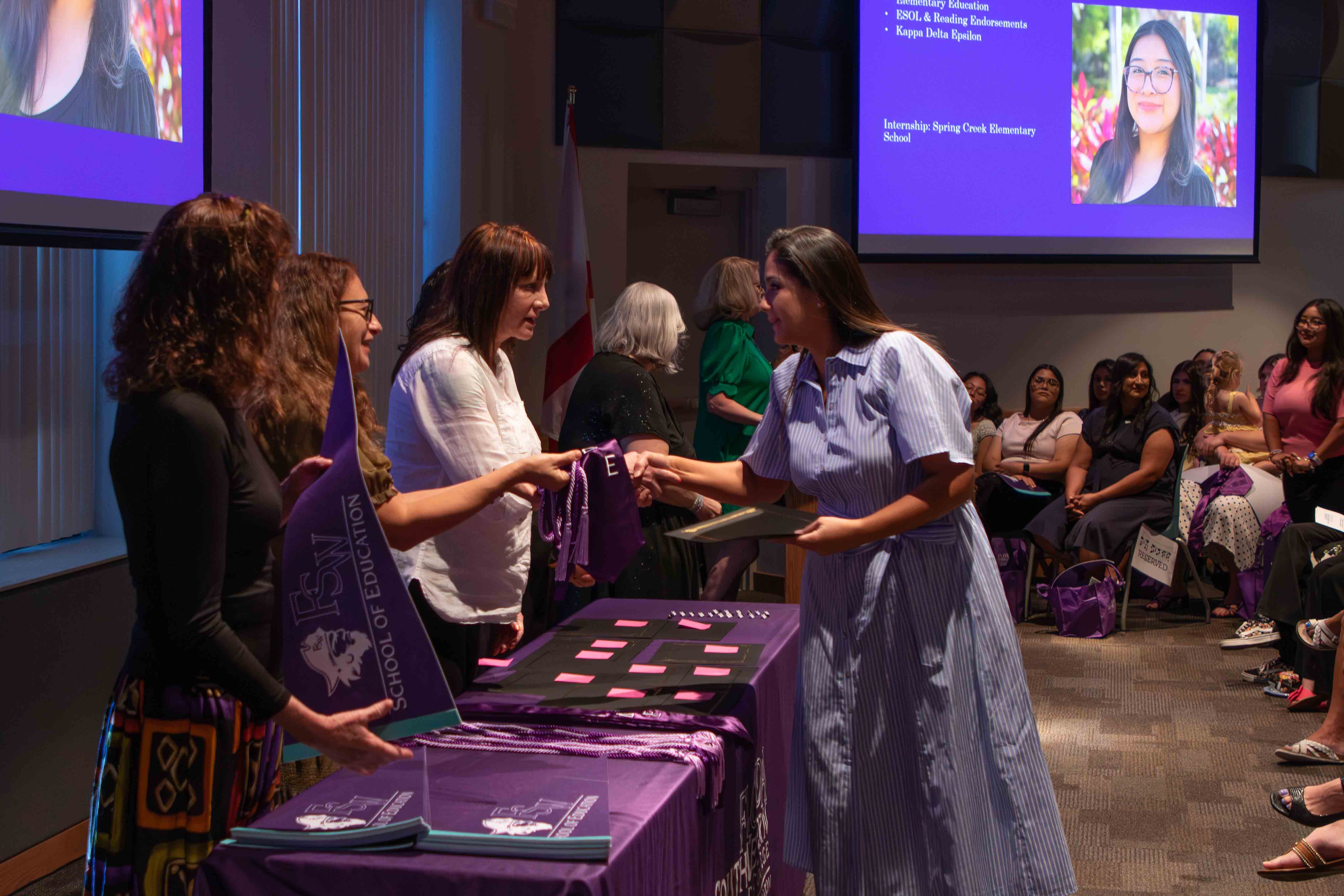 Students accept their pins in recognition of completing their final semester of study.
