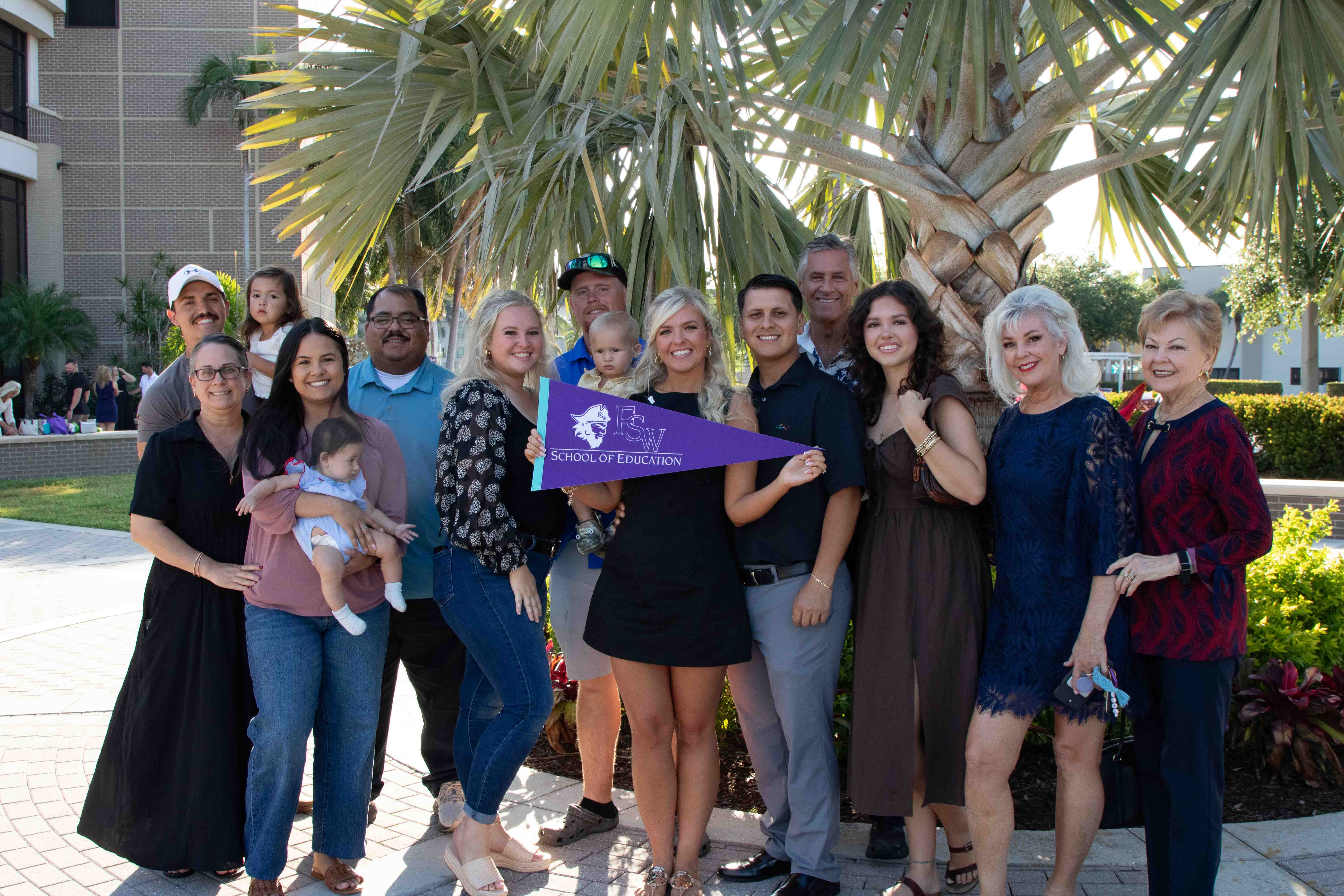 Keely Mckinney celebrates with her family at the conclusion of FSW's School of Education Pinning Ceremony.