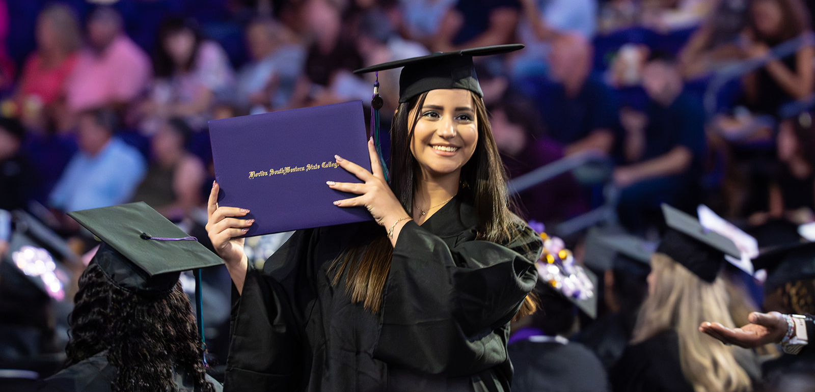 FSW graduate with diploma.