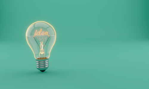 Lightbulb on teal bacground displaying the word "idea"