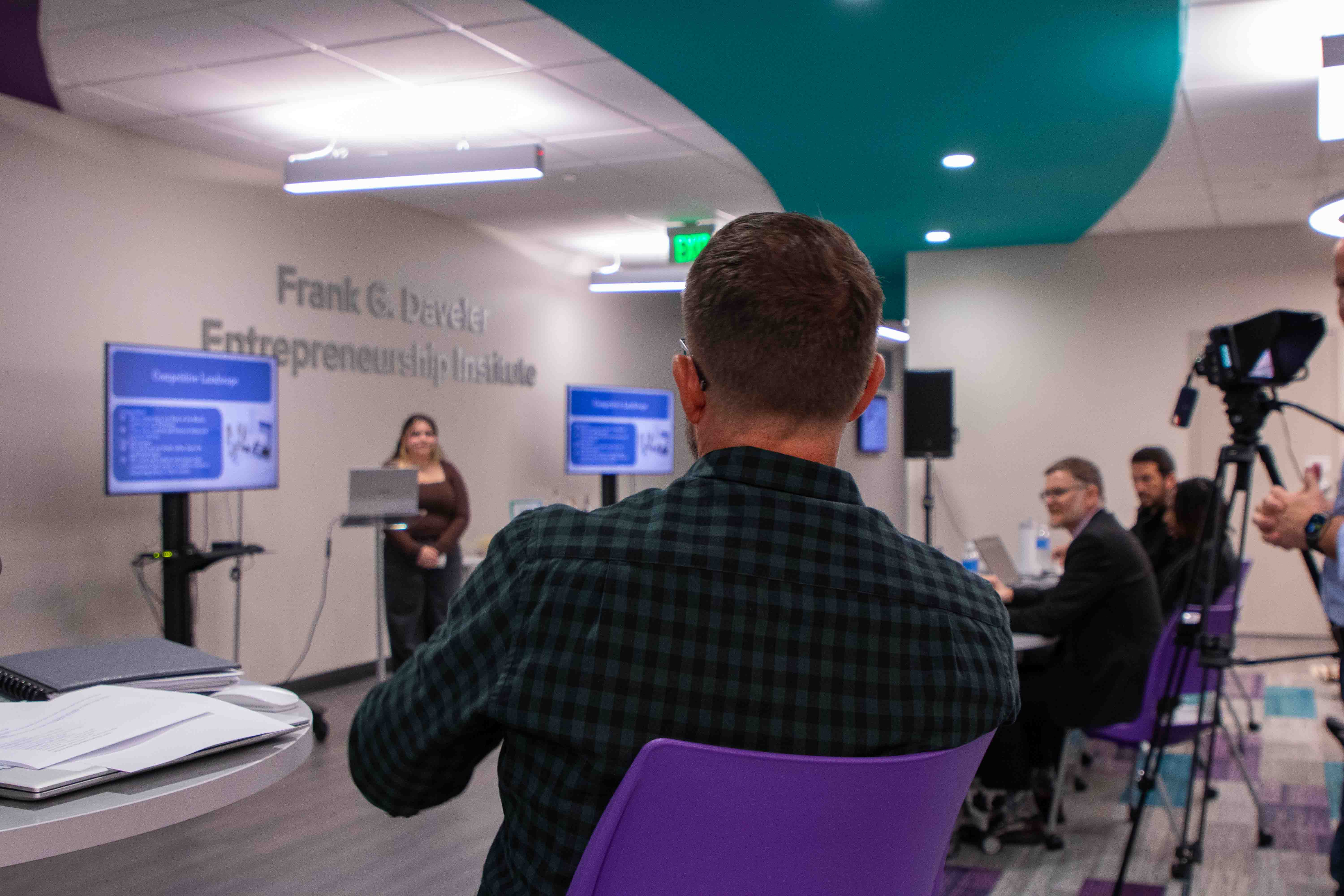 Judges and audience members listen to Hailey Deeb’s pitch for a monthly book club subscription service offering personalized “book of the month” boxes.