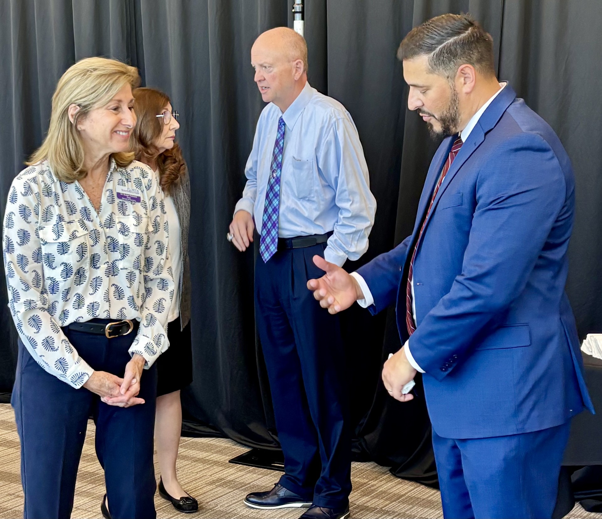 Dr. Susan Holland discusses ACEN accreditation with Florida Commissioner of Education Anastasios Kamoutsas during FSW’s commencement ceremony.